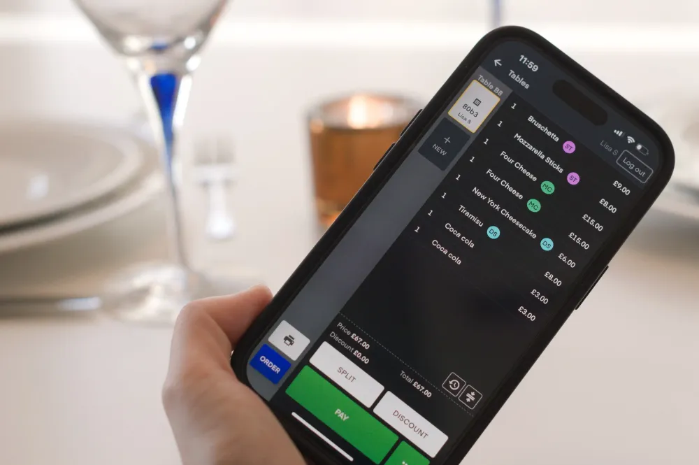 A hand holding a phone showing the POS