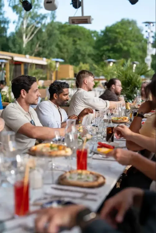 The baemingo team eating in a restaurant taking with each other